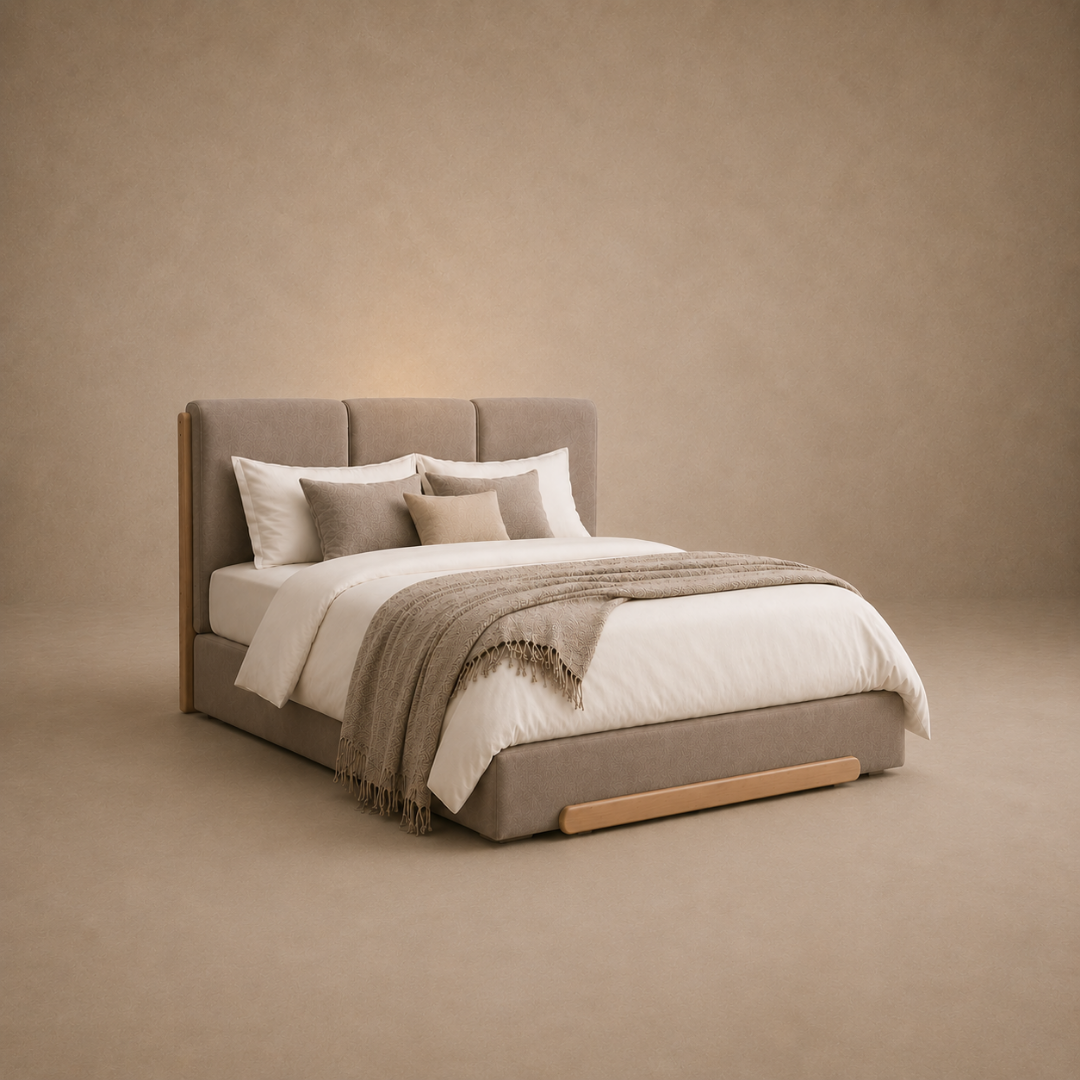 A modern upholstered bed with a tall segmented headboard and low frame, dressed in white bedding and a taupe throw blanket, set against a warm beige textured wall and floor.